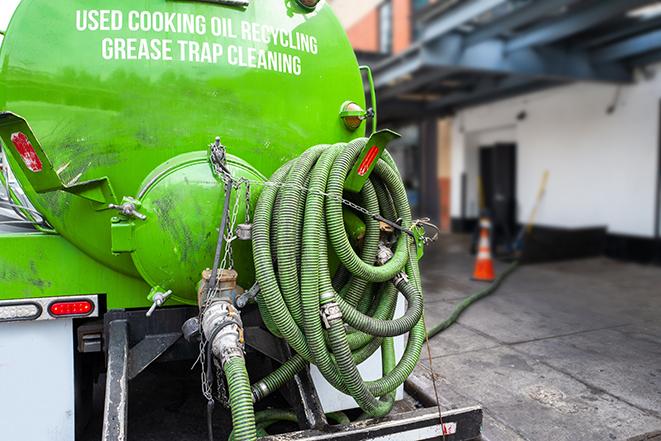 a technician pumping a grease trap in a commercial building in Cold Spring, NY